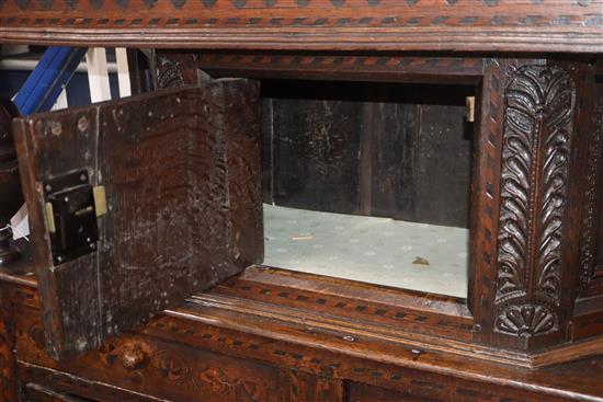 A 17th century marquetry inlaid oak court cabinet W.127cm